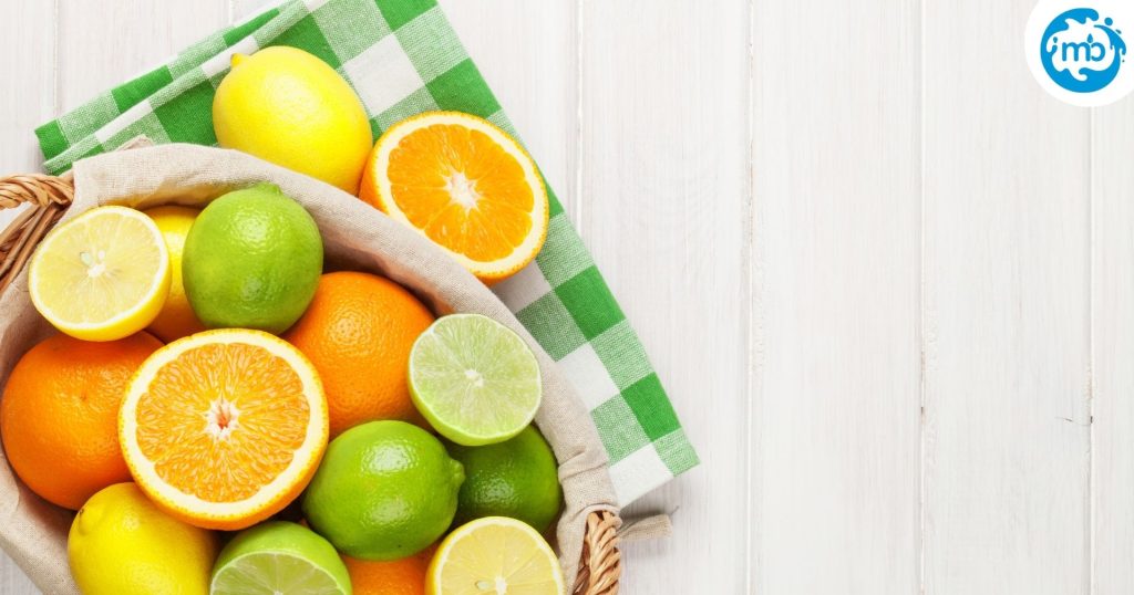 Cut citrus fruits in a wood basket and tea towel
