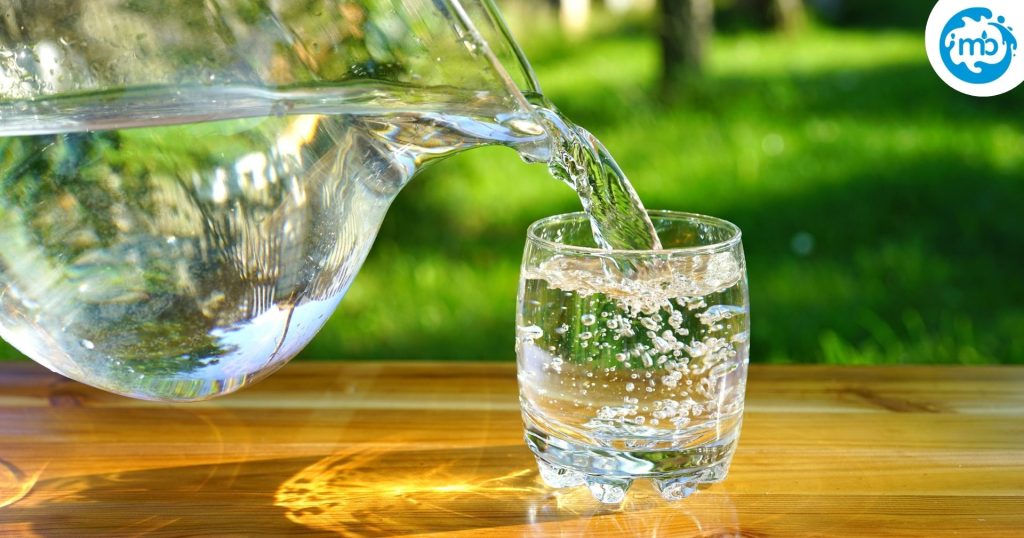 A glass of fresh water being filled