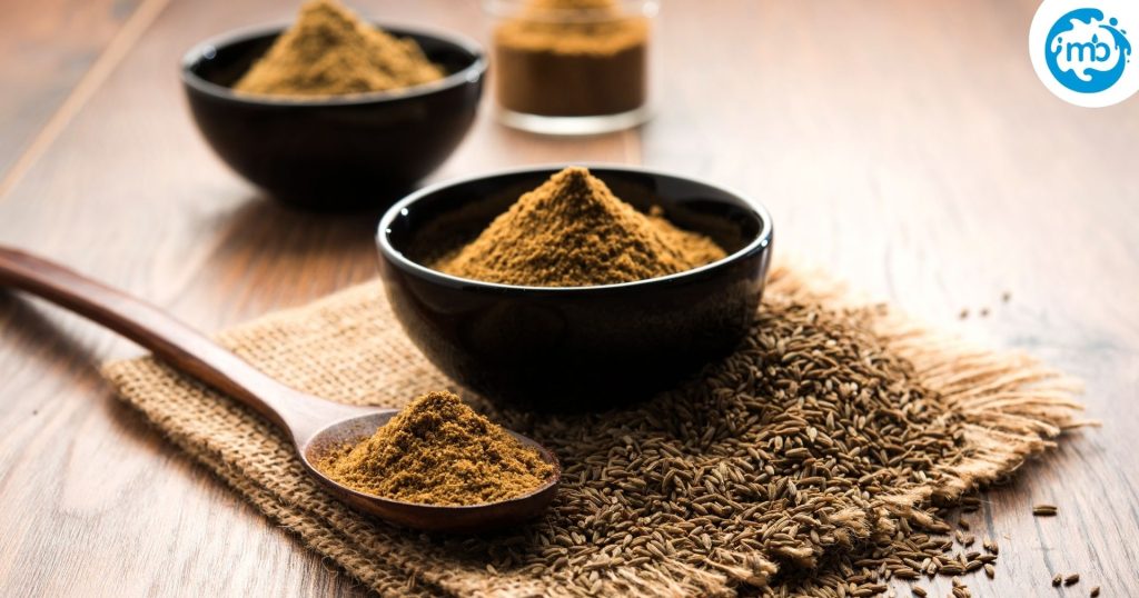 Jeera Powder or ground roasted cumin seeds on a wooden surface