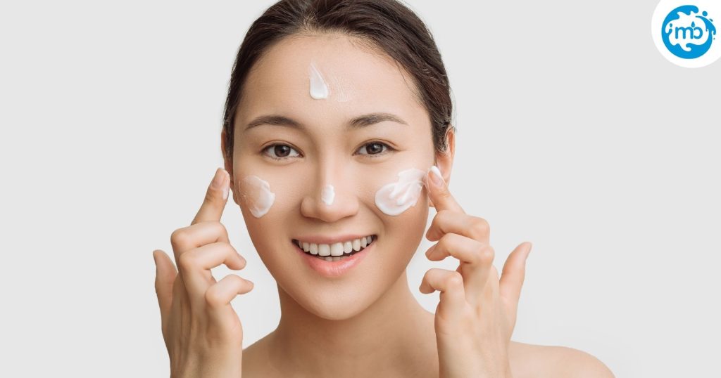 woman moisturizing her face, lotion on her skin