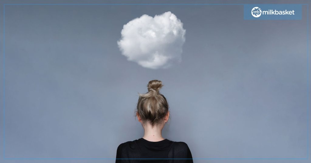 A woman standing in the frame with a white cloud above her head