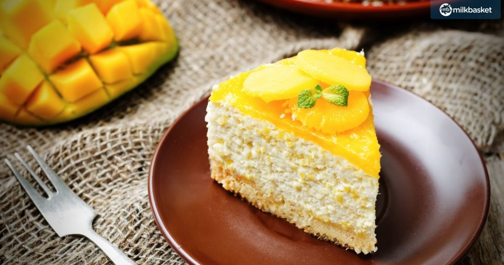 a slice of creamy mango mousse cake on a wooden plate 