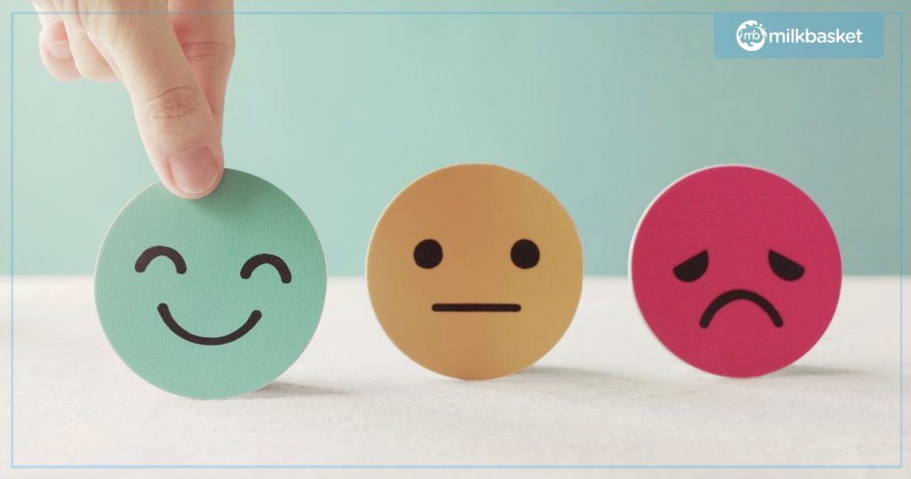 Three smiley buttons on a pastel background