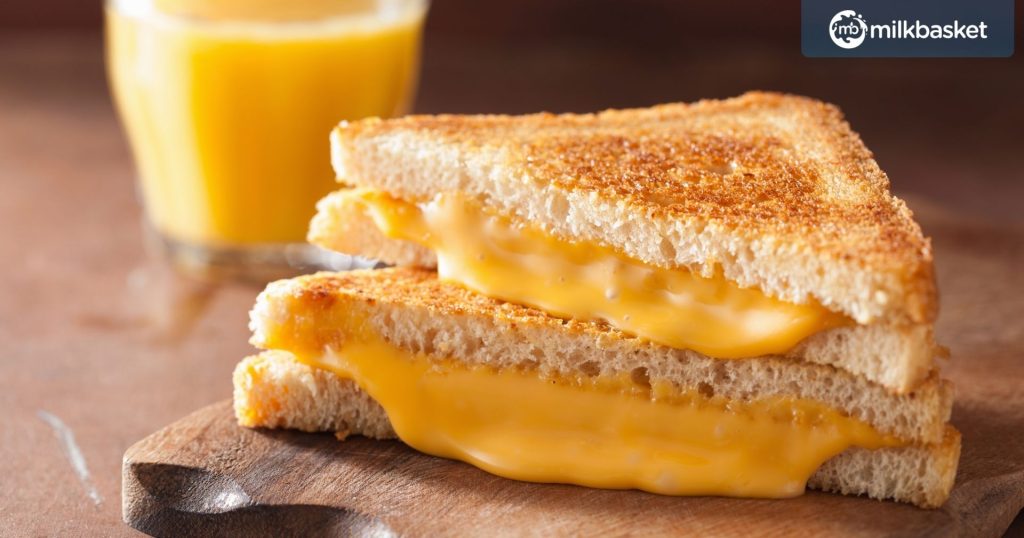 homemade grilled cheese sandwich for sliced with yellow cheese oozing out