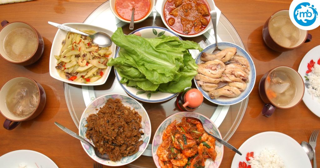 Asian food laid out for dinner on a wooden table, served for Chinese New Year reunion.