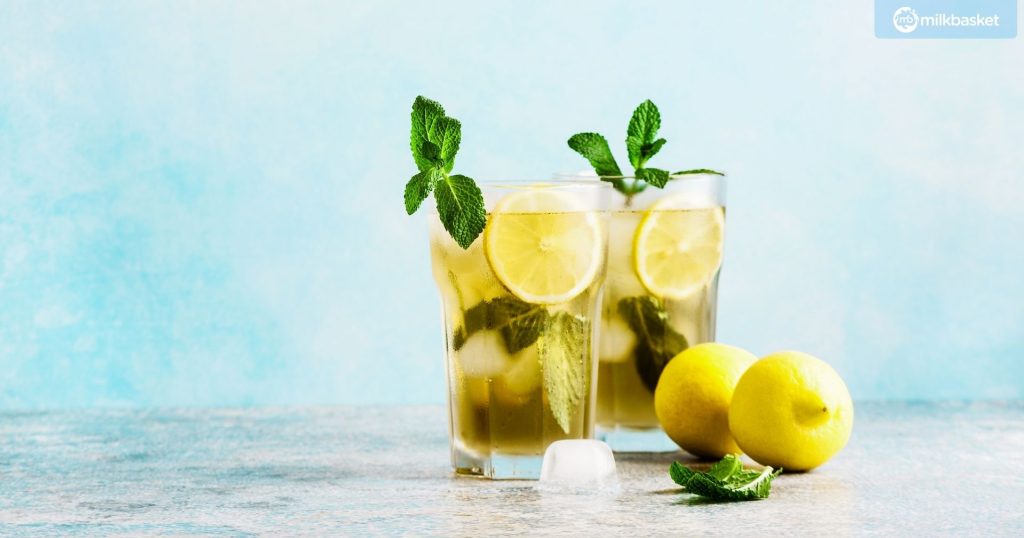 iced tea with lemon and fresh mint in transparent glasses