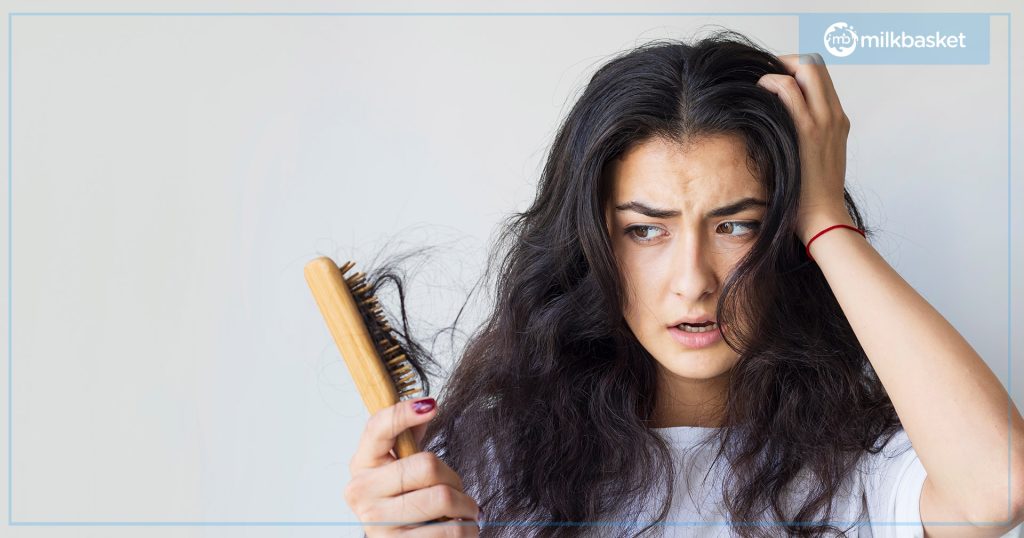 Woman being shocked looking at the hair fall