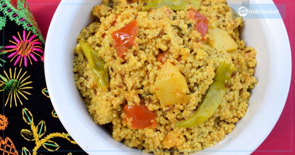 A white bowl full of kodo millet and vegetable upma which is one of the healthiest breakfast recipes to make.
