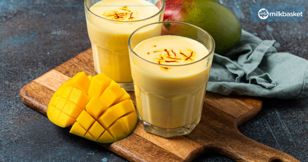 Enjoy a delicious mango smoothie with mango slices, a popular summer drink known as mango lassi