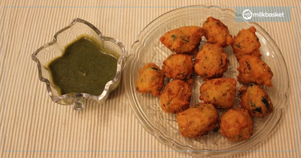 Green Moong Dal Vada served with green chutney on a clear glass plate - a delicious and crispy green moong dal recipe