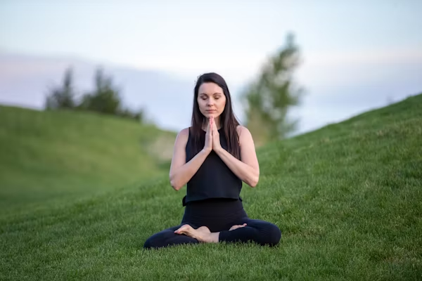Girl in black yoga clothes doing meditation to avoid stress.