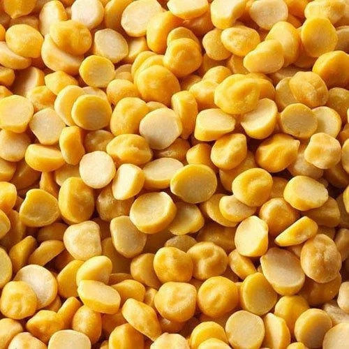 Close-up of a bowl filled with vibrant orange masoor dal (red lentils), highlighting its suitability for healthy dal recipes, set against a dark wooden background.