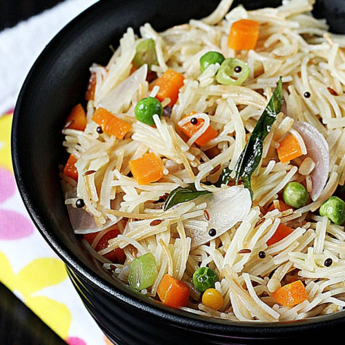A bowl of veg vermicelli loaded with colorful vegetables like carrots, peas, and onions, representing a wholesome and healthy breakfast option that's quick and easy to prepare.