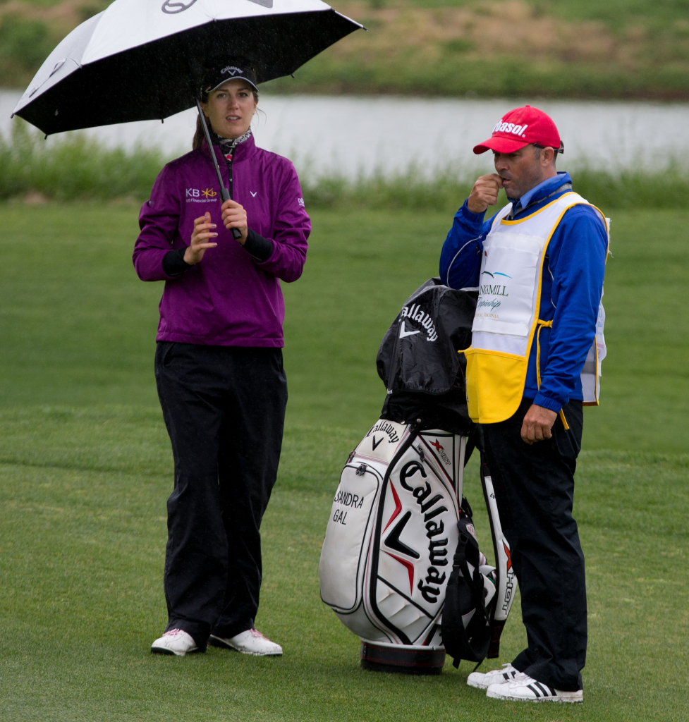 golfer holding a golf umbrella