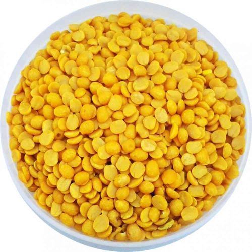 A bowl filled with bright yellow toor dal, ideal for healthy dal recipes, displayed against a plain background.