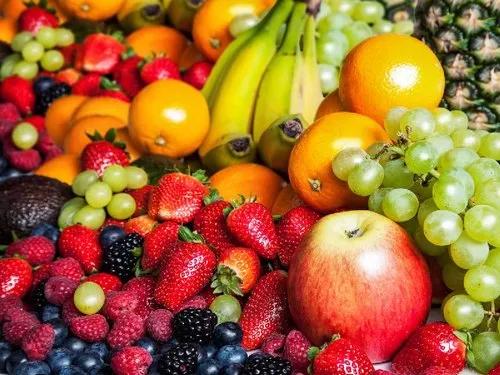 A vibrant assortment of fresh fruits including bananas, oranges, apples, strawberries, grapes, and berries - perfect for fasting during Janmashtami 2024.