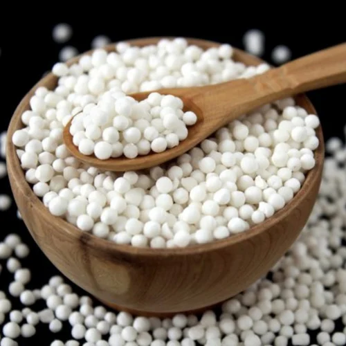 A wooden bowl filled with sabudana, a popular ingredient used in fasting recipes like sabudana khichdi for Janmashtami 2024.