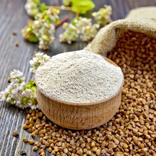 A bowl of buckwheat flour with scattered buckwheat grains, commonly used to make fasting dishes like puris during Janmashtami 2024.