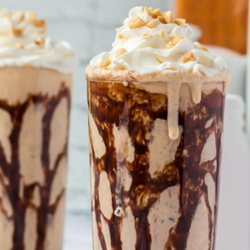 Peanut butter chocolate milkshake recipe drizzled with chocolate syrup and topped with whipped cream and chopped peanuts for a nutty indulgence.