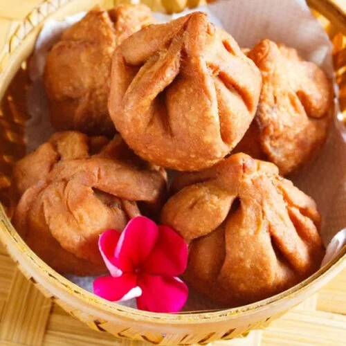 A bowl filled with fried modak for ganesh chathurthi